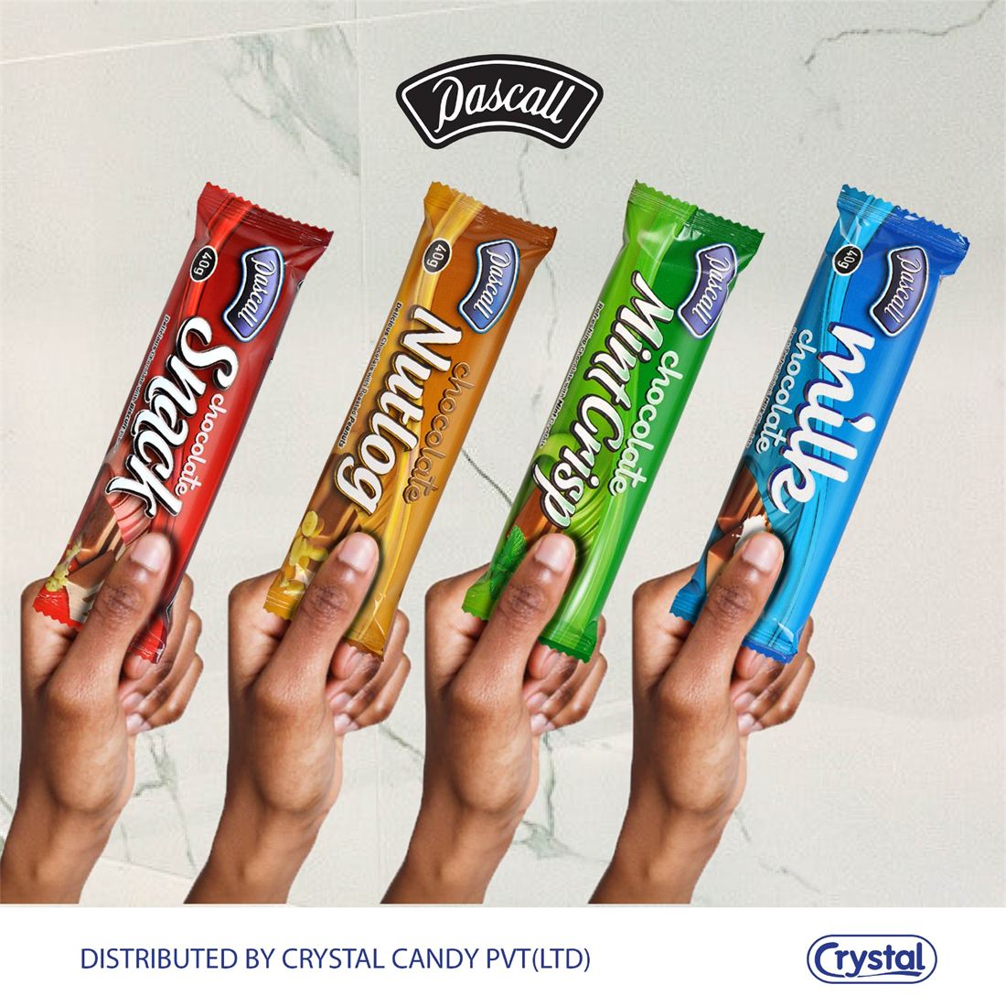 Hands holding up Pascall Snack, Nutlog, Mint Crisp and Milk bars