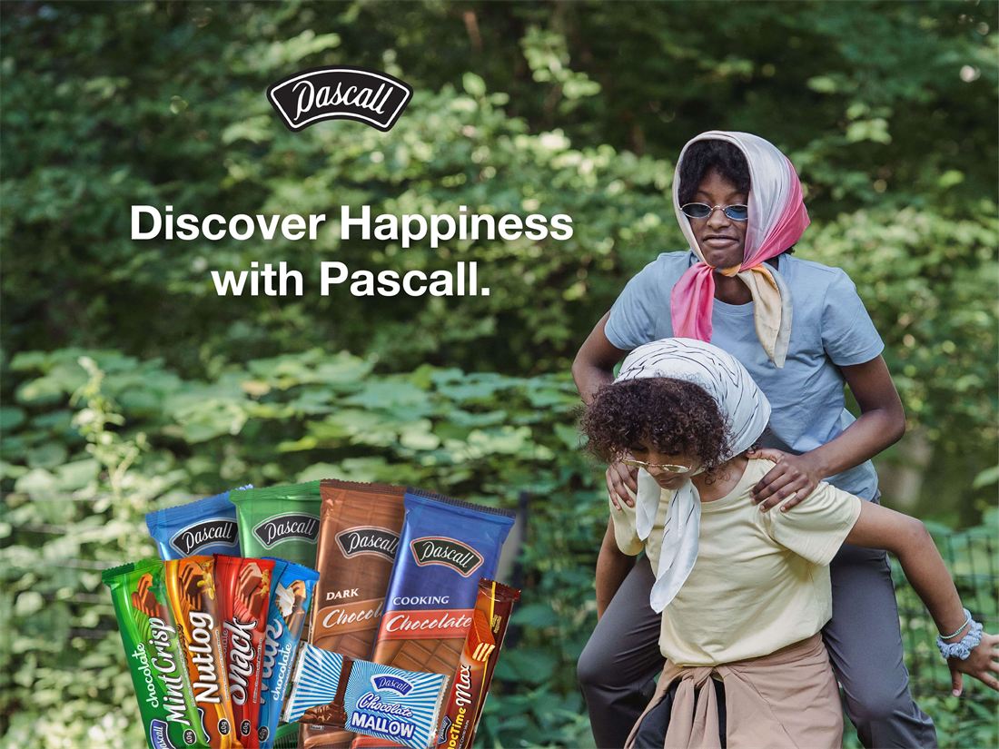 A mother and child laughing outdoors with Pascall chocolate bars